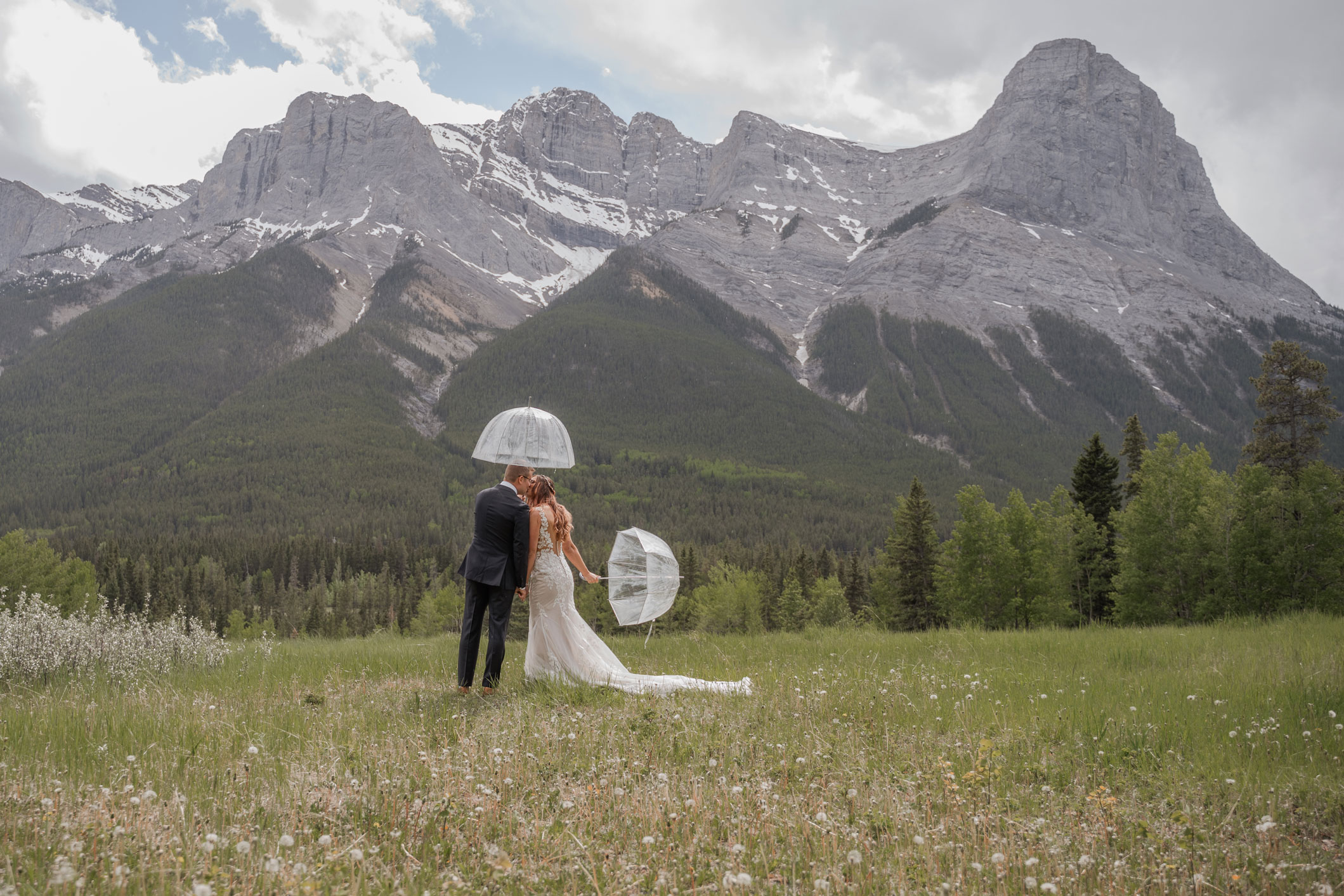 Canmore Rockies Wedding Couple Under Umbrellas at Rundleview Park